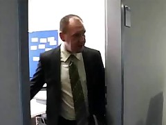 An office nymph is getting bossed around by her who is cursing and vowing at her. Meanwhile her colleague, an aged man, is off in his office. She over to him and takes all of her raiment off in order to be fucked by him.
